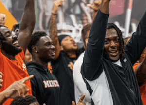 Mercer football players react to their playoff seeding